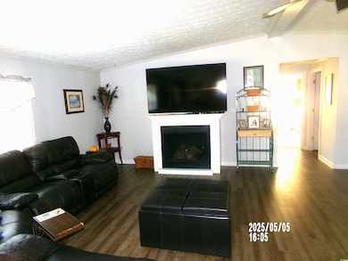 Living area with a textured ceiling, wood finished