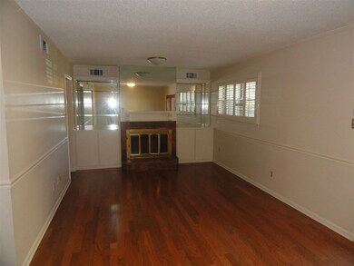 The living room has new hardwood flooring and a fi