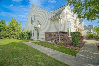 View of home's exterior featuring brick siding, a lawn, and a shingled roof