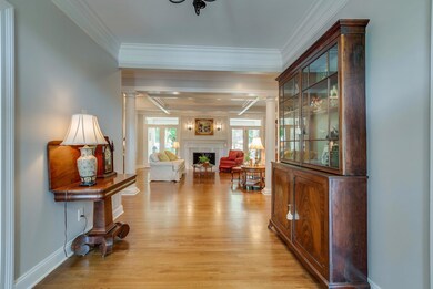 WALK IN FOYER CROWN MOLDING CUSTOM FOYER LIGHT SAND N SEAL HARDWOOD FLOORING LOTS OF NATURAL LIGHTING EXPANSIVE FOYER DIMMABLE LIGHTING
