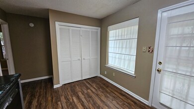 Entryway featuring a textured ceiling and dark woo