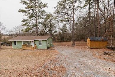 View of front of house featuring a wooden deck and