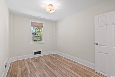 Spare room with visible vents and light wood-style
