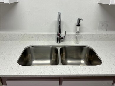 Details with light stone countertops and sink