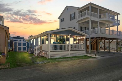View of front facade with a porch, a lawn, a carpo