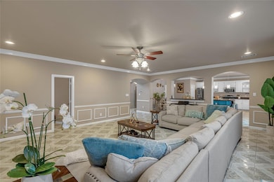 Living area with a decorative wall, a ceiling fan,
