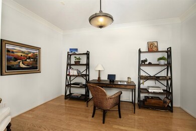 Spacious study, located off the entry way with French doors, wood floors and crown moulding.