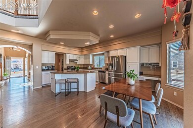 Dining room with dark wood-type flooring, recessed