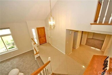 Vaulted ceiling over the formal entryway with coat
