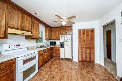 Kitchen featuring white appliances, sink, ceiling