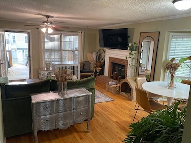 Stylish decor features fireplace and dining room.