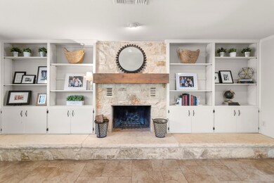 Living room with a fireplace, visible vents, and 