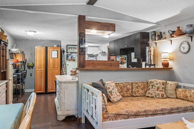 Living area featuring dark wood-type flooring and a textured ceiling