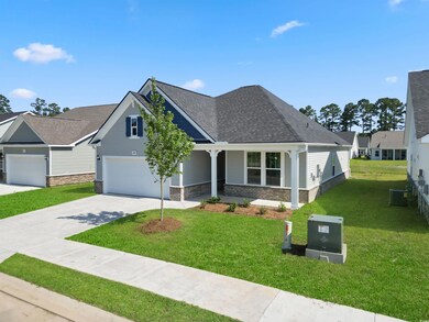 View of front of property with a garage, a front yard, and central air condition unit