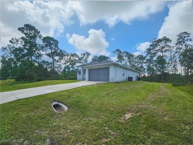 View of side of home with a garage, cooling unit,