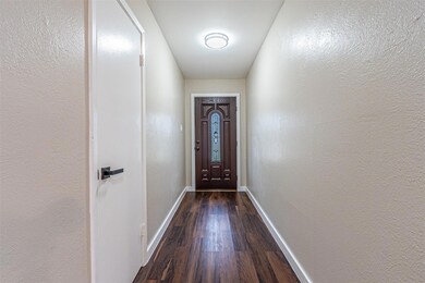 Doorway to outside with dark wood-style floors, a 