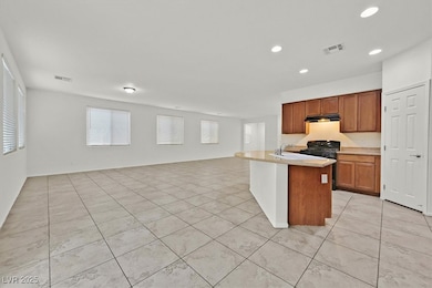 Kitchen with open floor plan, gas stove, light til