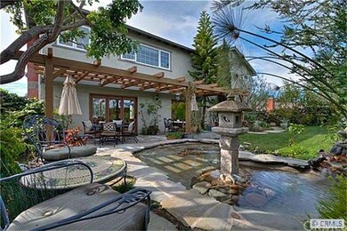 Backyard with pond that has a waterfall