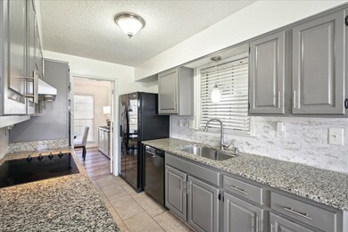 Kitchen featuring black appliances, gray cabinets,