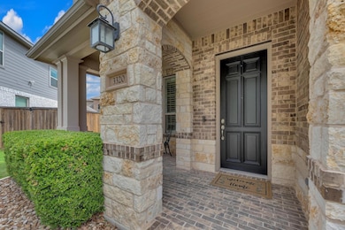 Entrance to property featuring stone siding and f