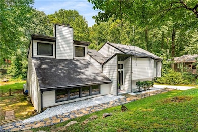 Back of house featuring a lawn