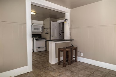 Kitchen with white appliances, dark countertops, 