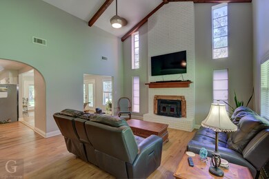 Living room featuring beamed ceiling, a wealth of 