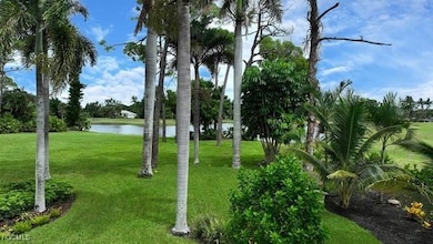 View of property's community featuring a yard and a water view