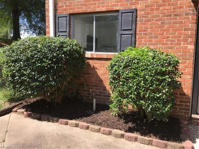 Fresh mulch and double window allowing natural light into the kitchen