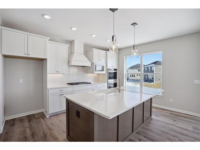 The stunning gourmet kitchen features a double wal