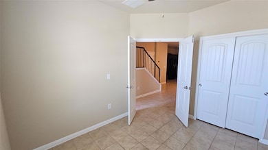 Unfurnished bedroom with light tile patterned flo