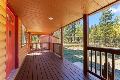 Deck featuring a yard and a storage unit