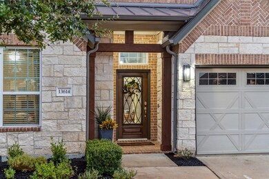 The front exterior is adorned with brick and stone accents