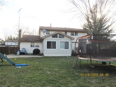 View of back of home with 3 season sun room and pa