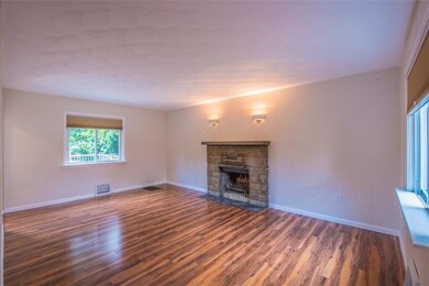 Spacious Living Room with Wood-Burning Fireplace. 