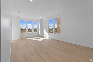 Spare room with light wood finished floors and recessed lighting