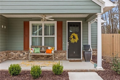 Entrance to property with brick siding, covered po