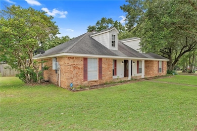 View of front of home with brick siding and a shingled roof