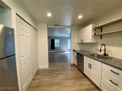 Kitchen featuring stainless steel appliances, a si