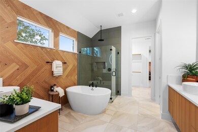 Bathroom with vanity, a freestanding tub, lofted 