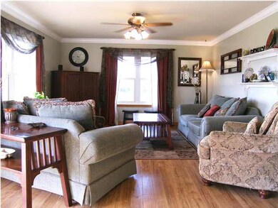 The living room features lots of natural light, a 