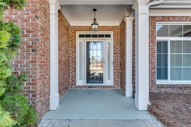 View of exterior entry featuring brick siding