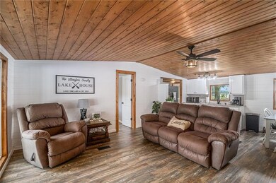 Living area with visible vents, dark wood finished floors, vaulted ceiling, and wooden ceiling