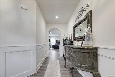 Large foyer with decorative trim and arched doorwa