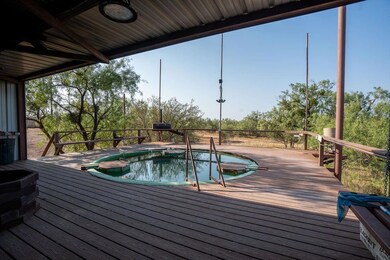 View of pool featuring a wooden deck and a hot tub