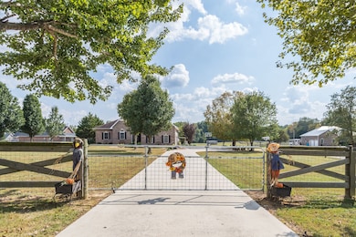 Gated front entrance with concrete driveway.