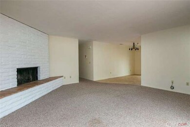 Living room opens to dining and kitchen.