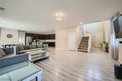 Living room with stairway, light wood finished flo