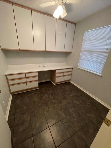 Unfurnished office with built in desk, a ceiling 