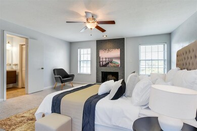 Spacious Master Bedroom with cozy wood burning fir
